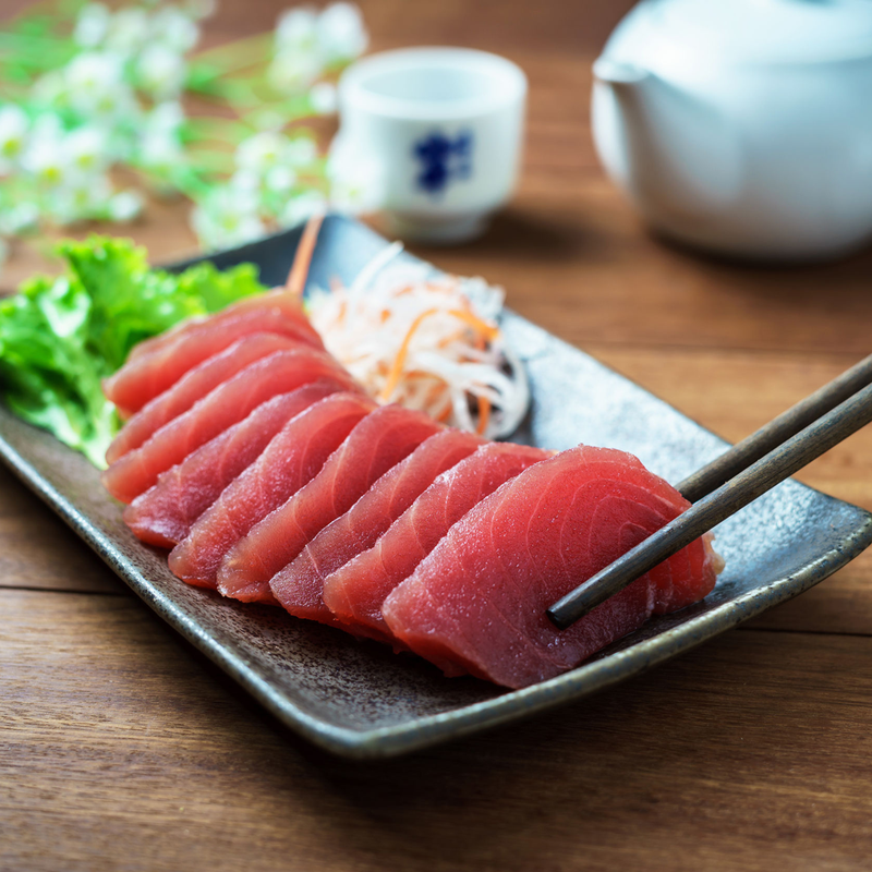 Raw Sashimi Grade yellowfin tuna (Ahi) on plate 